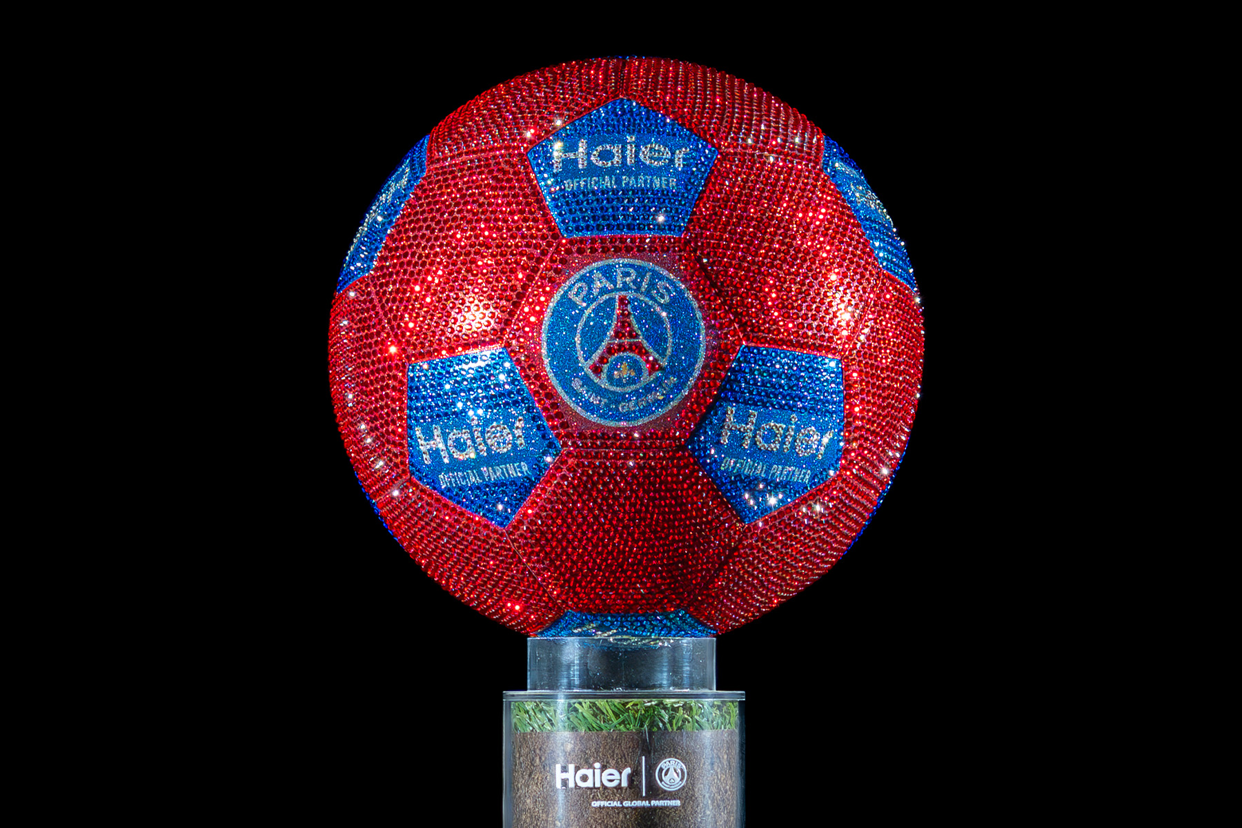 Luxury football covered with Swarovski crystals, featuring Haier branding and the PSG emblem. with it own custom support.